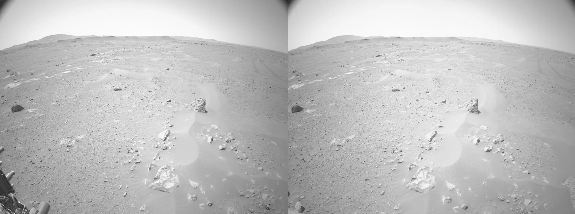 Paired grayscale views from Perseverance navigation cameras show rocks and sandy terrain ahead on Mars.